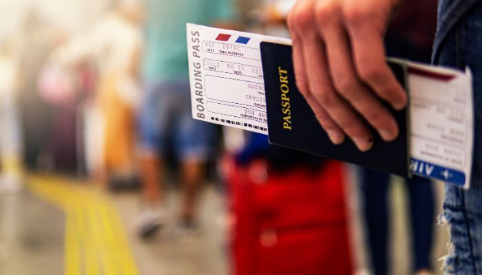 Travellers holding his passport